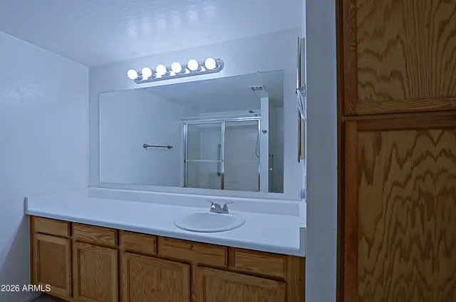 a bathroom with a glass shower door