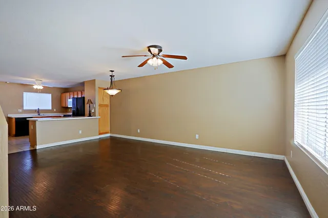a view of a kitchen with wooden floor and a window