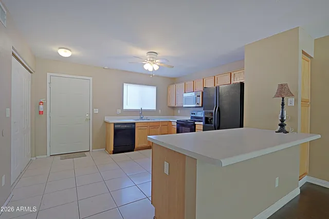 a kitchen with stainless steel appliances a refrigerator sink and stove