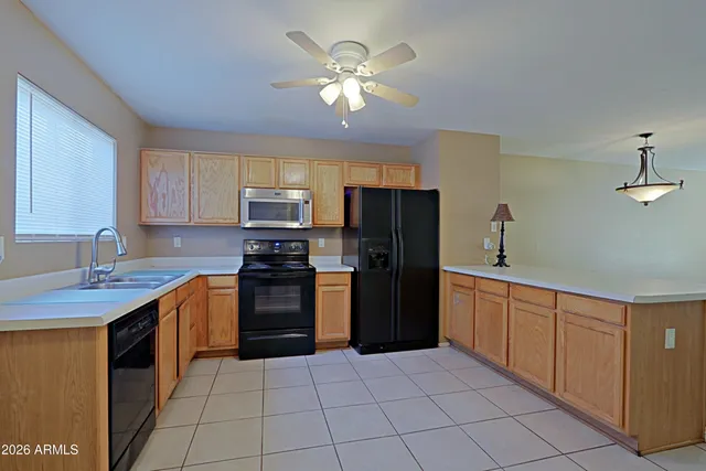 a kitchen with stainless steel appliances granite countertop a stove refrigerator and cabinets