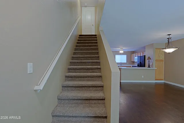 a view of a hallway with wooden floor and entryway