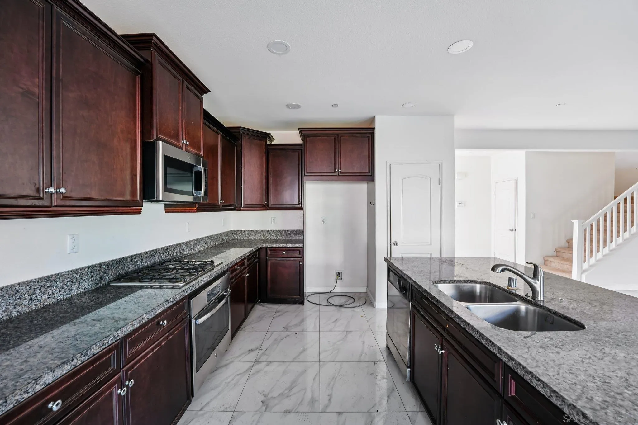 31890 Rouge Lane Menifee, CA 92584 - Photo 2 of 40 a kitchen with granite countertop a sink stove and cabinets