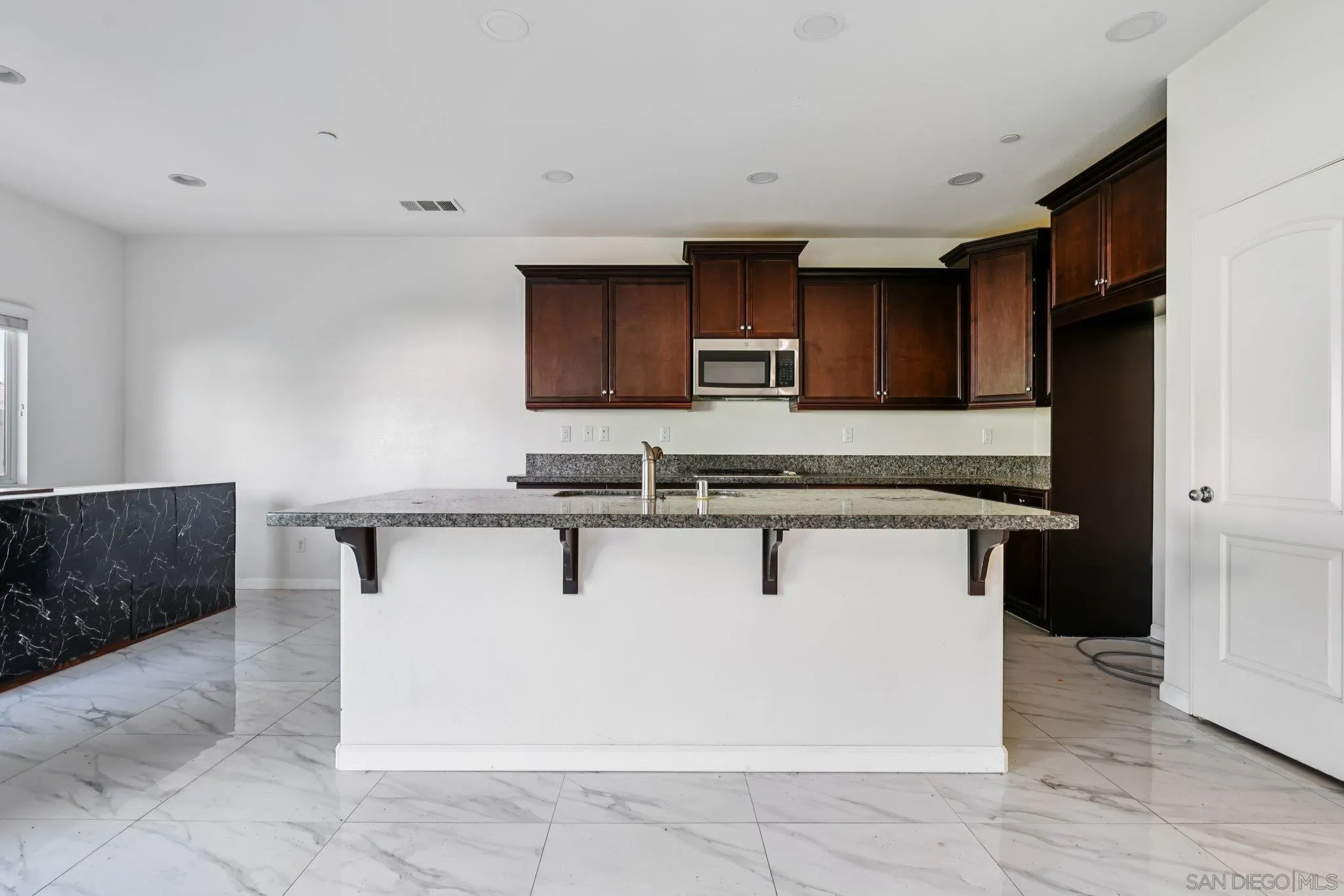 31890 Rouge Lane Menifee, CA 92584 - Photo 3 of 40 a kitchen with stainless steel appliances a sink stove and microwave
