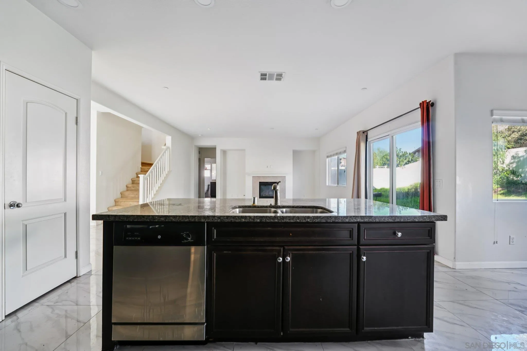 31890 Rouge Lane Menifee, CA 92584 - Photo 4 of 40 a kitchen with granite countertop a sink and cabinets