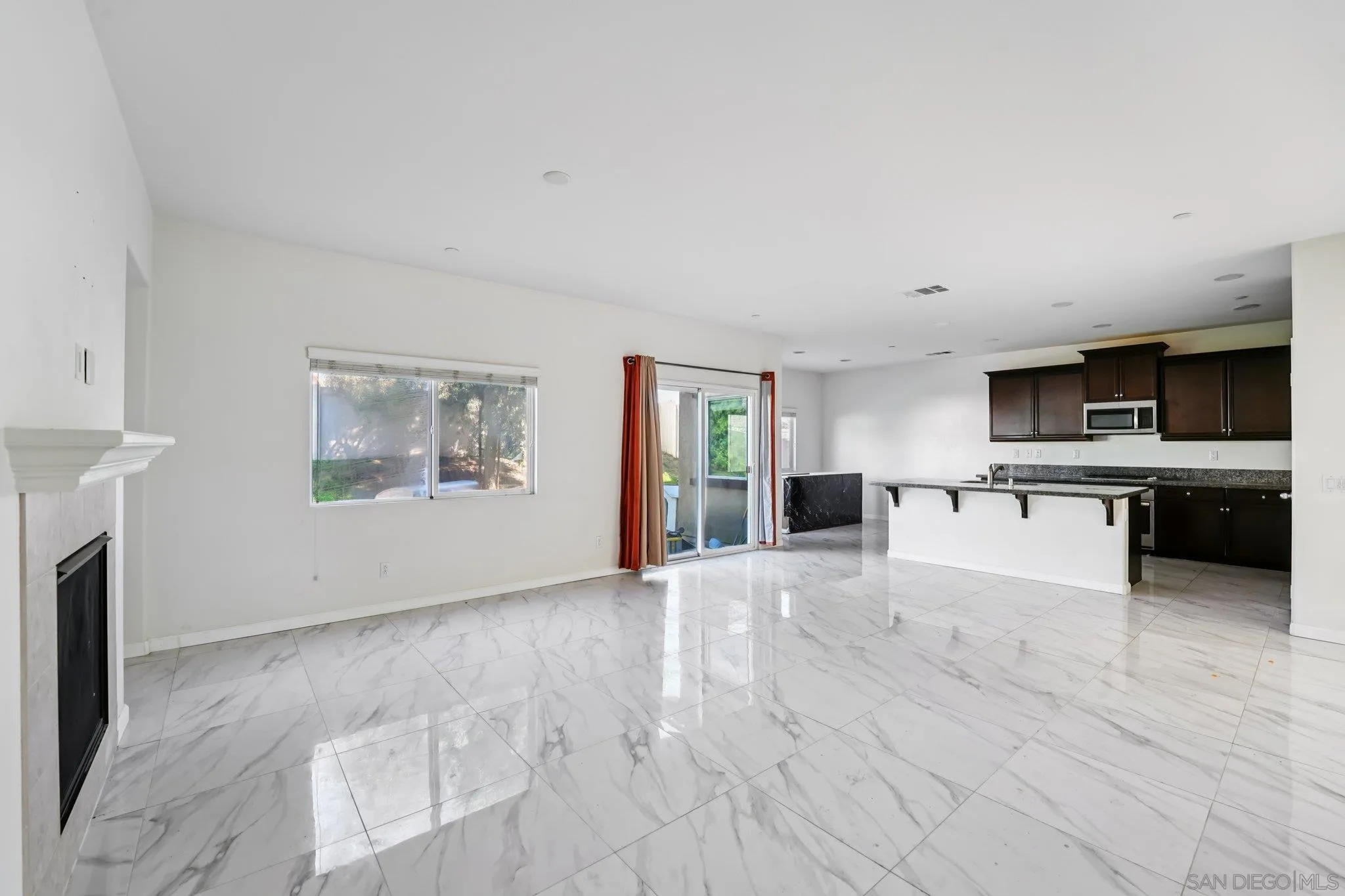 31890 Rouge Lane Menifee, CA 92584 - Photo 6 of 40 a view of a kitchen with a sink cabinets and a living room