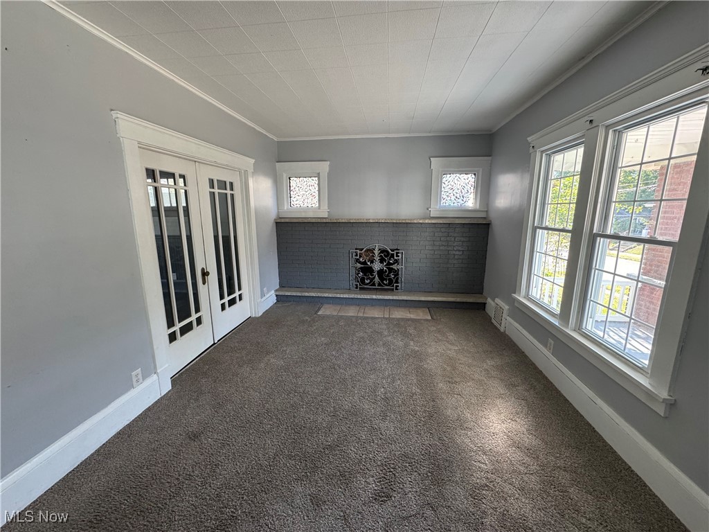 2425 7th Street Northwest Canton, OH 44708 - Photo 6 of 19 Carpeted empty room with french doors and crown molding