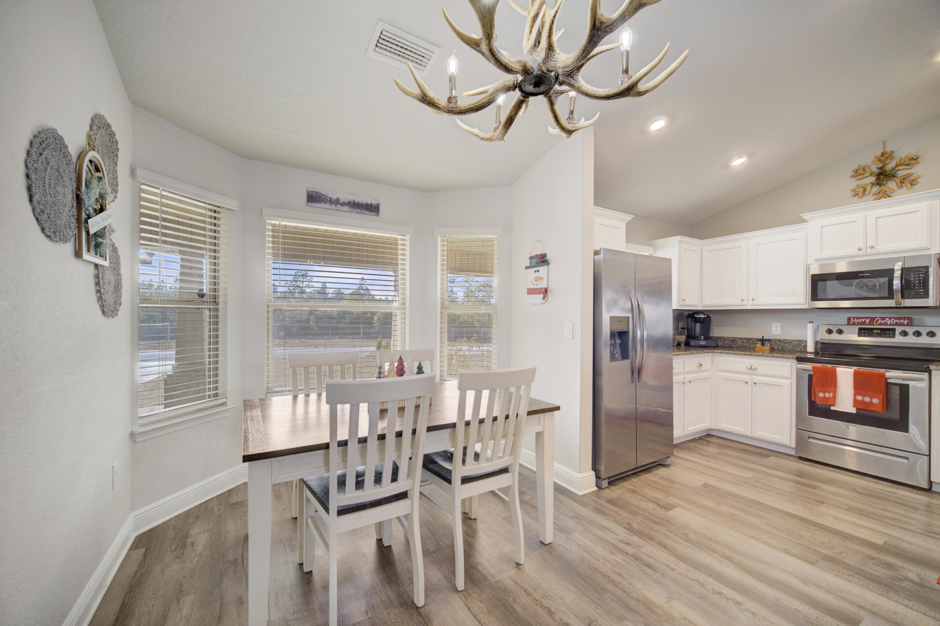2045 Broad Street Crestview, FL 32536 - Photo 12 of 36 a view of a dining room with furniture window and wooden floor