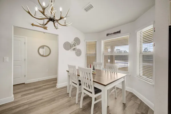 a view of a dining room with furniture window and wooden floor