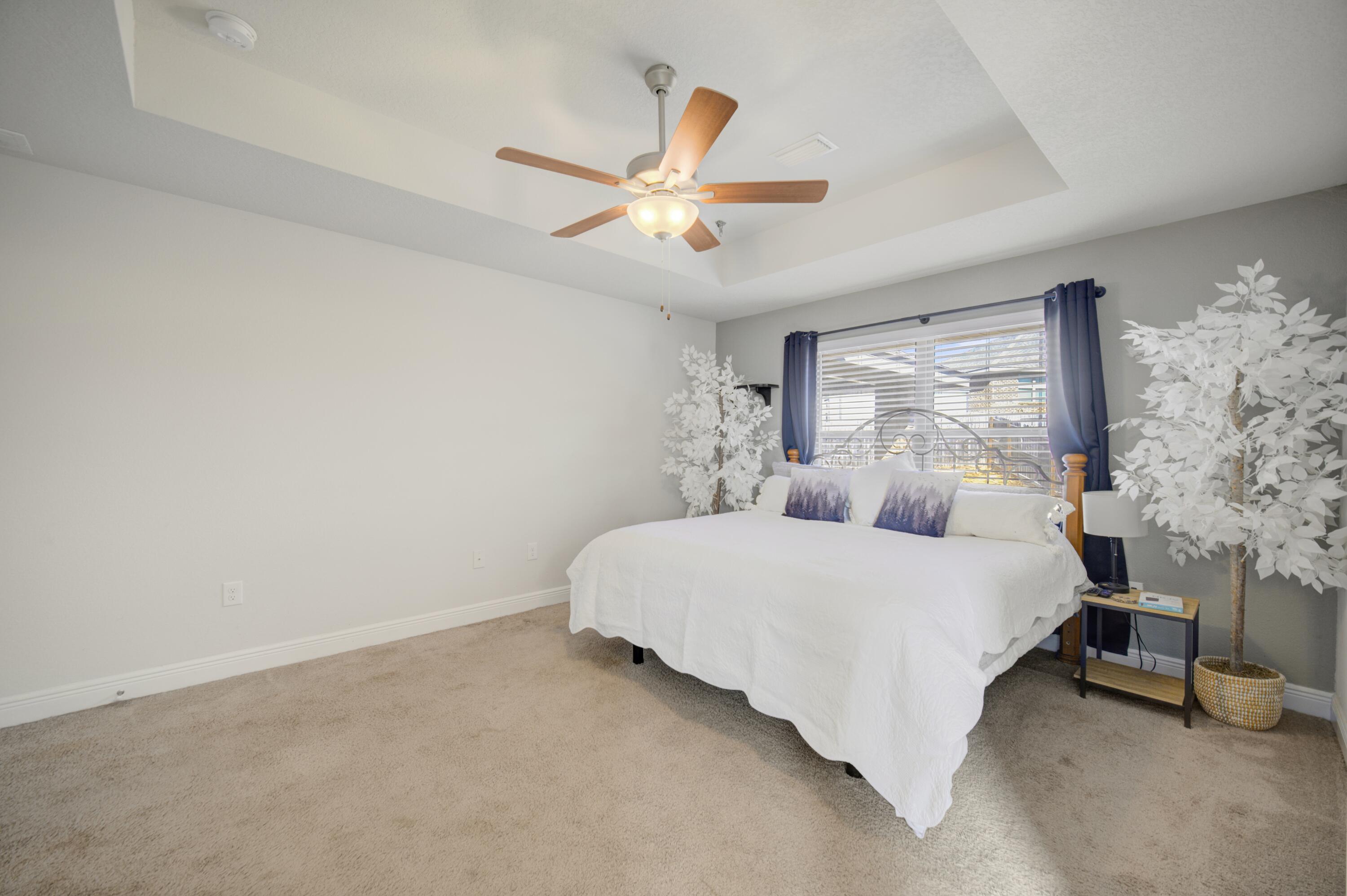 2045 Broad Street Crestview, FL 32536 - Photo 15 of 36 a bedroom with a bed and a chandelier