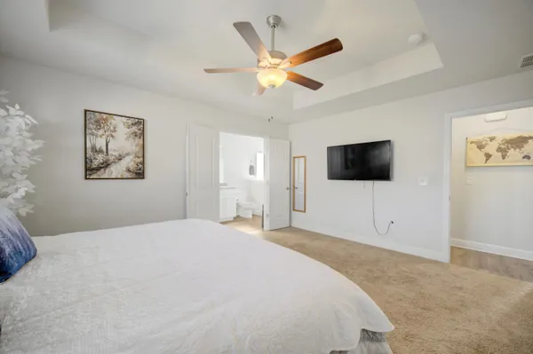a bedroom with a bed and a flat screen tv