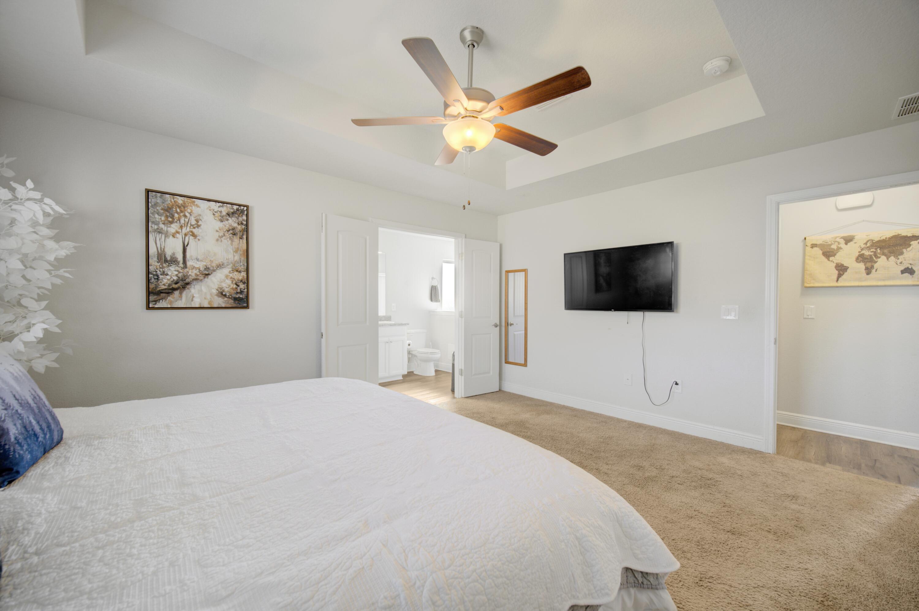 2045 Broad Street Crestview, FL 32536 - Photo 16 of 36 a bedroom with a bed and a flat screen tv