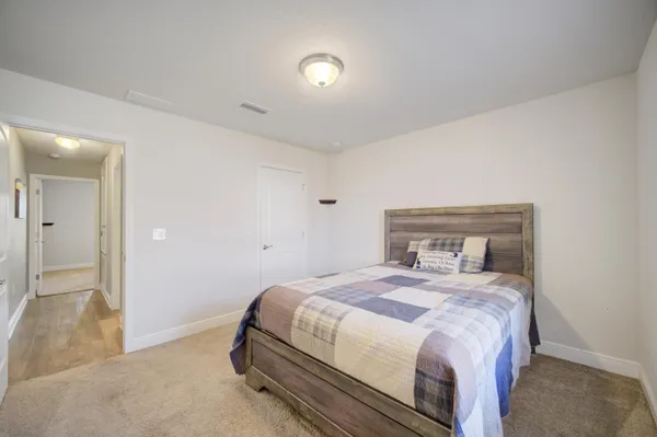 a bedroom with a bed and a lamp