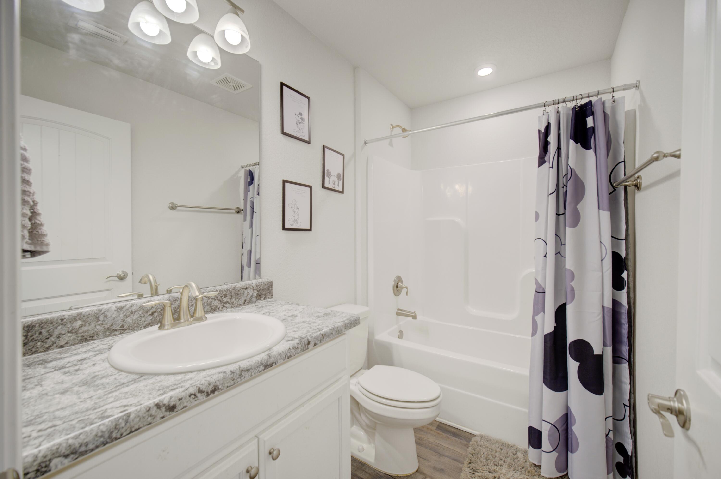 2045 Broad Street Crestview, FL 32536 - Photo 27 of 36 a bathroom with a granite countertop sink toilet and shower