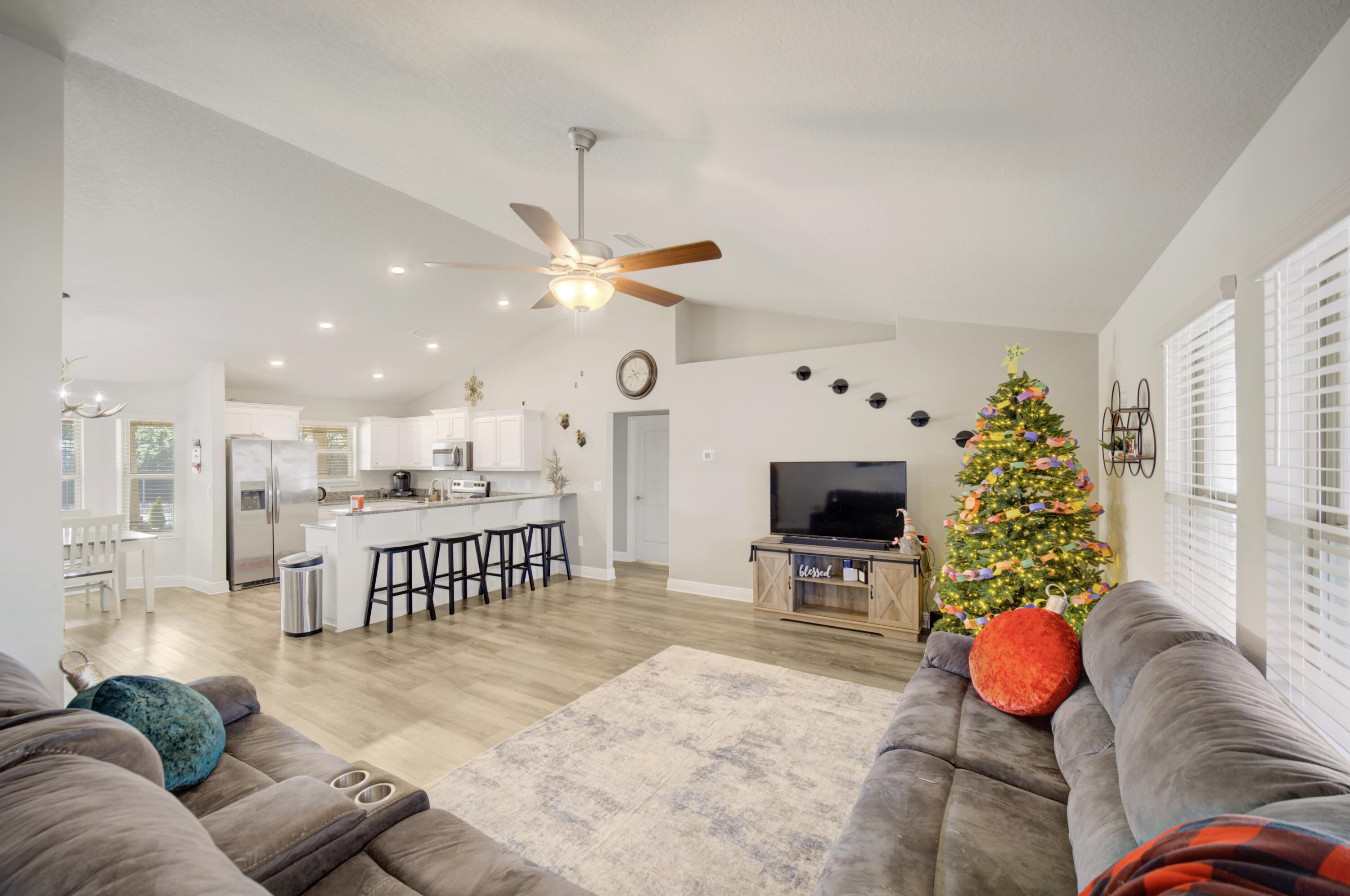 2045 Broad Street Crestview, FL 32536 - Photo 5 of 36 a living room with furniture potted plant and a chandelier