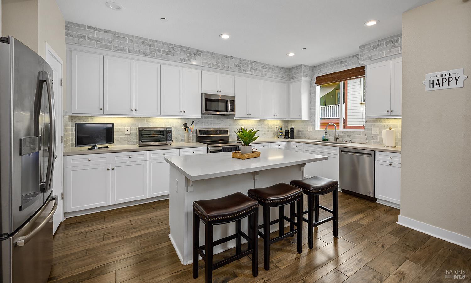 228 Johnson Street Windsor, CA 95492 - Photo 17 of 32 a kitchen with a sink a microwave a refrigerator and cabinets