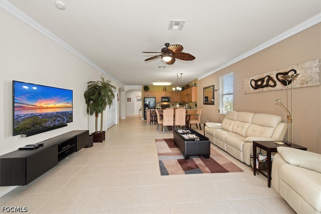 14951 Reflection Key Circle, Unit 531 Fort Myers, FL 33907 - Photo 13 of 36 a living room with furniture and a flat screen tv