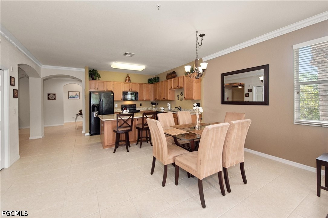 14951 Reflection Key Circle, Unit 531 Fort Myers, FL 33907 - Photo 14 of 36 a dining room with furniture and window