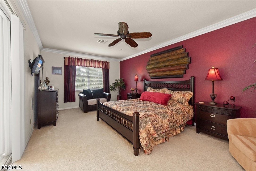 14951 Reflection Key Circle, Unit 531 Fort Myers, FL 33907 - Photo 16 of 36 a bedroom with a bed and a chandelier