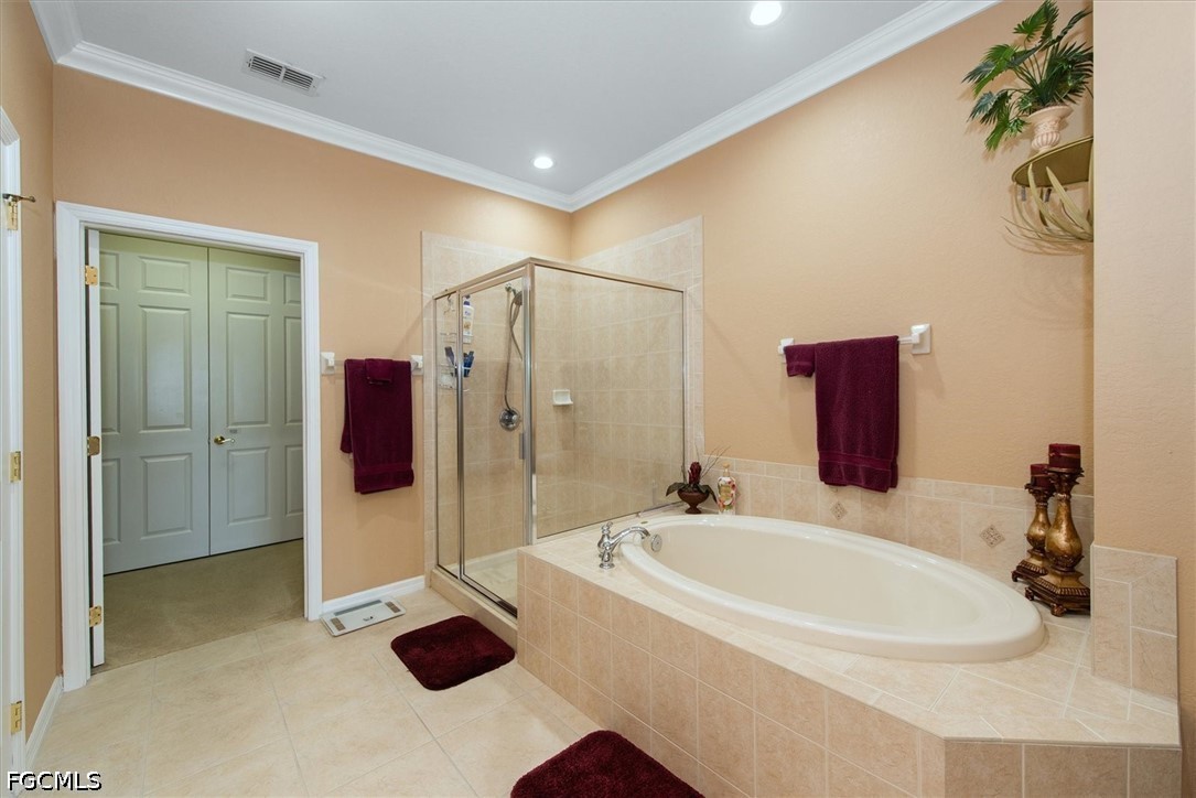 14951 Reflection Key Circle, Unit 531 Fort Myers, FL 33907 - Photo 20 of 36 a bathroom with a tub and a shower