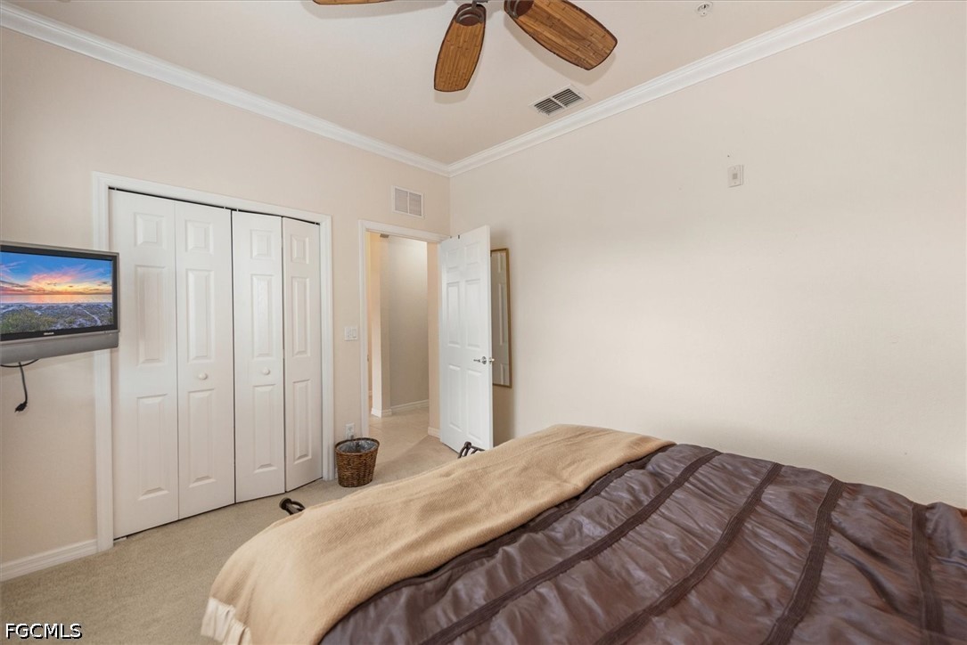 14951 Reflection Key Circle, Unit 531 Fort Myers, FL 33907 - Photo 22 of 36 a bedroom with a bed and a chandelier