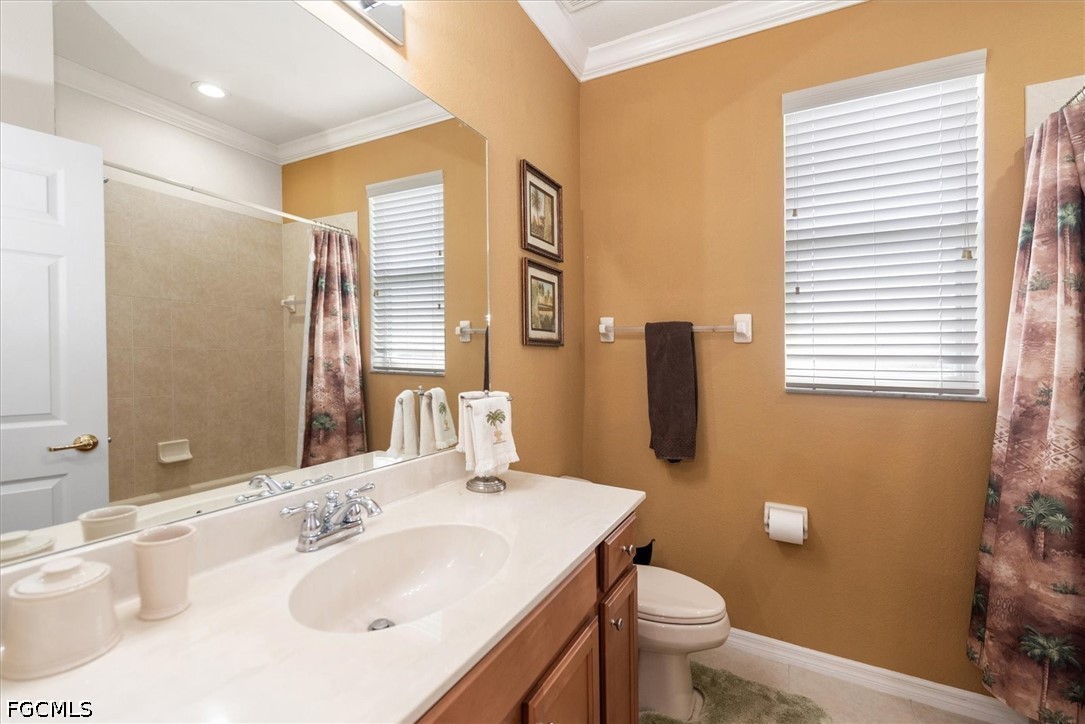 14951 Reflection Key Circle, Unit 531 Fort Myers, FL 33907 - Photo 23 of 36 a bathroom with a sink toilet and mirror