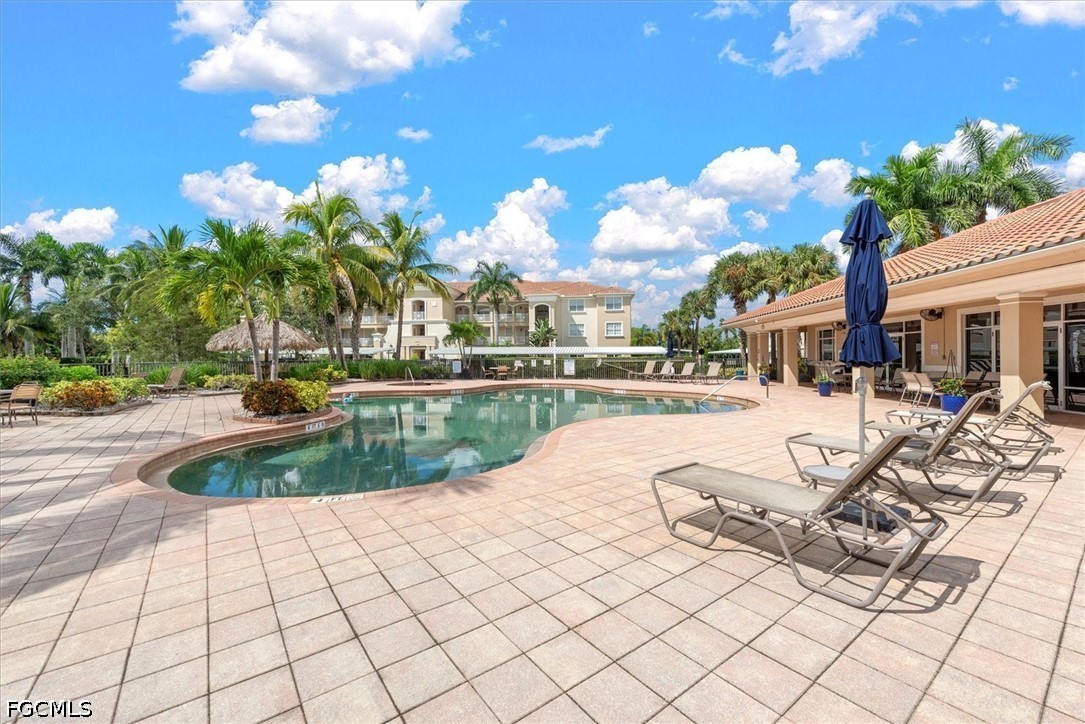 14951 Reflection Key Circle, Unit 531 Fort Myers, FL 33907 - Photo 27 of 36 a view of a swimming pool with a patio