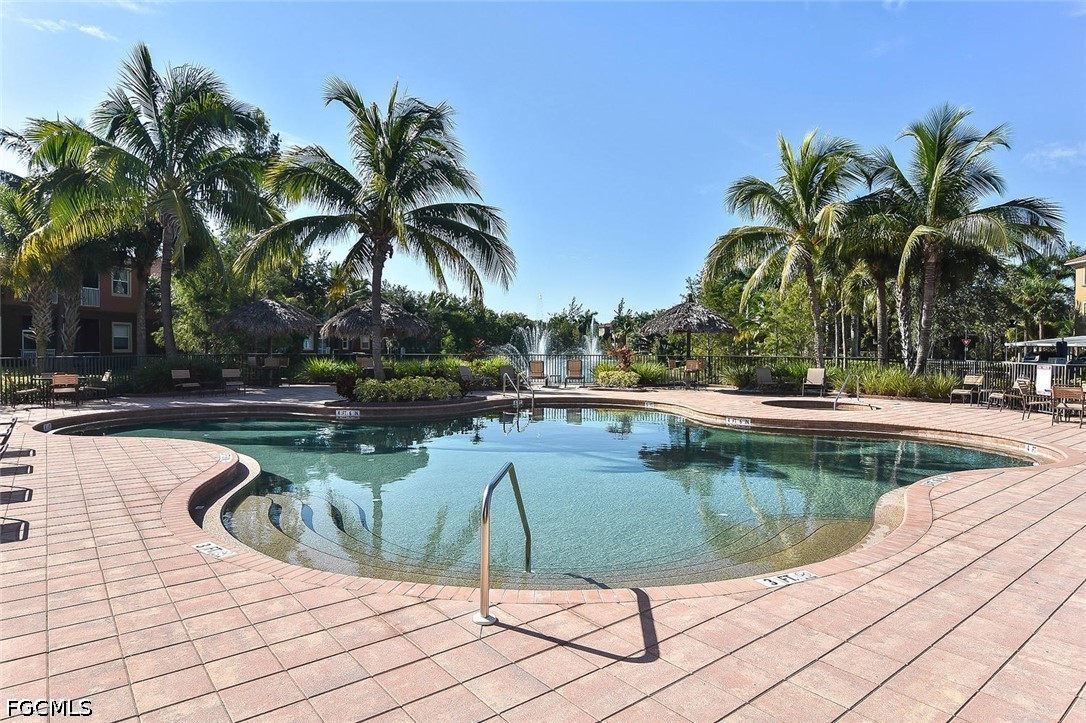 14951 Reflection Key Circle, Unit 531 Fort Myers, FL 33907 - Photo 29 of 36 a view of a swimming pool with a patio