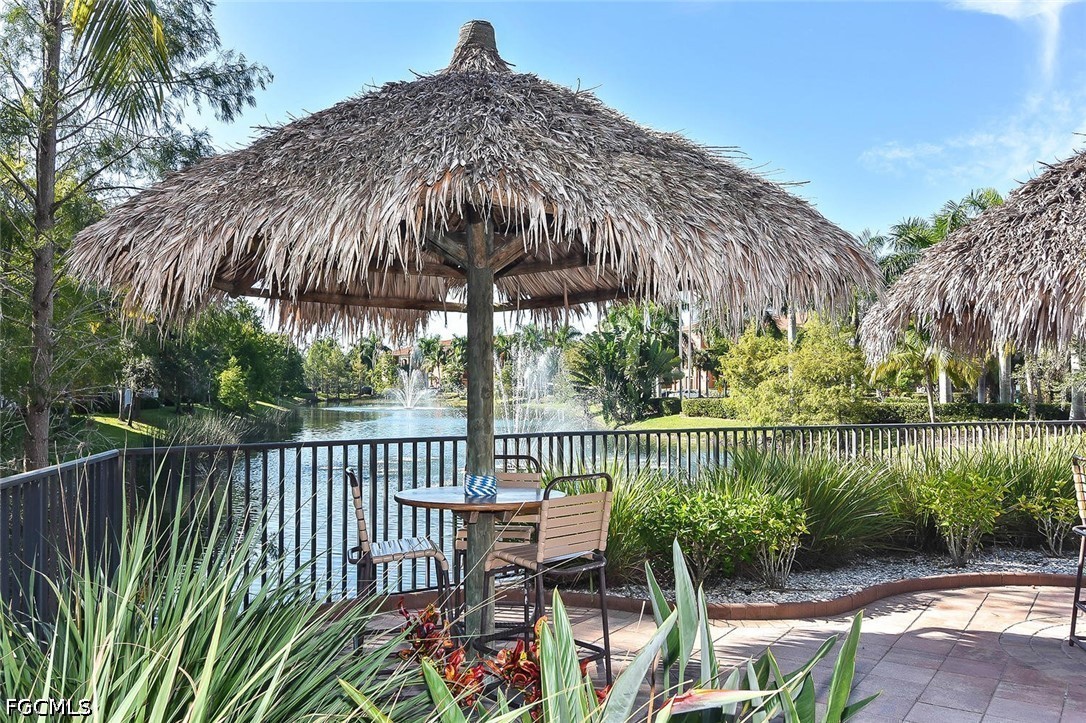 14951 Reflection Key Circle, Unit 531 Fort Myers, FL 33907 - Photo 31 of 36 a view of a patio with two chairs next to a yard