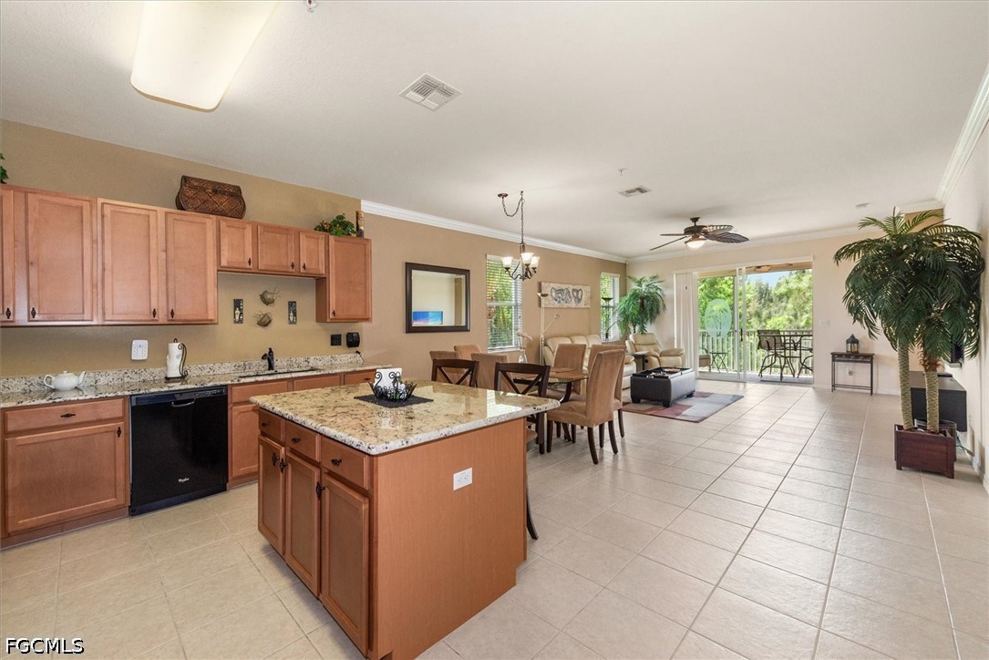 14951 Reflection Key Circle, Unit 531 Fort Myers, FL 33907 - Photo 8 of 36 a kitchen with stainless steel appliances granite countertop a stove top oven a sink dishwasher and white cabinets with wooden floor