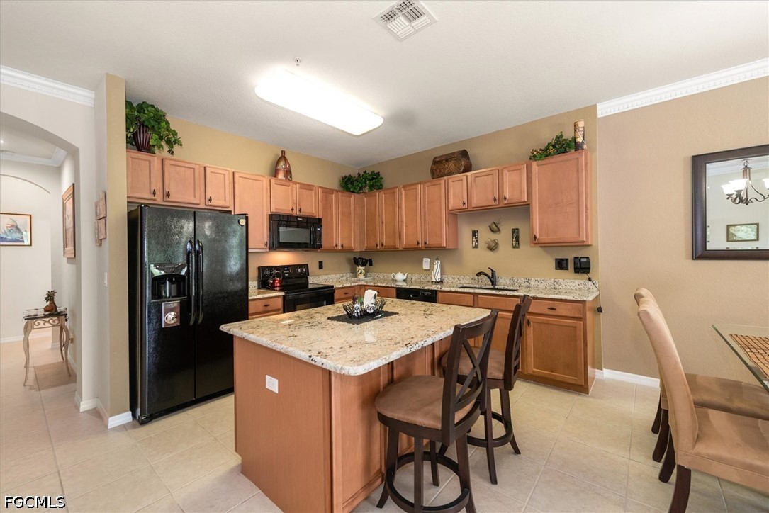 14951 Reflection Key Circle, Unit 531 Fort Myers, FL 33907 - Photo 9 of 36 a kitchen with a refrigerator a stove a sink a dining table and chairs