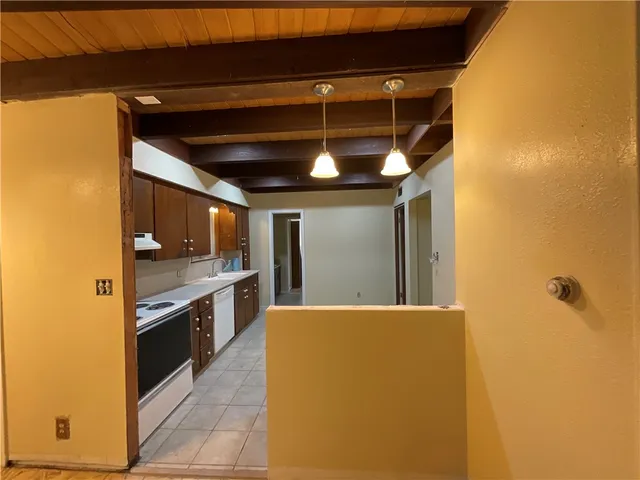 a view of a refrigerator and a stove