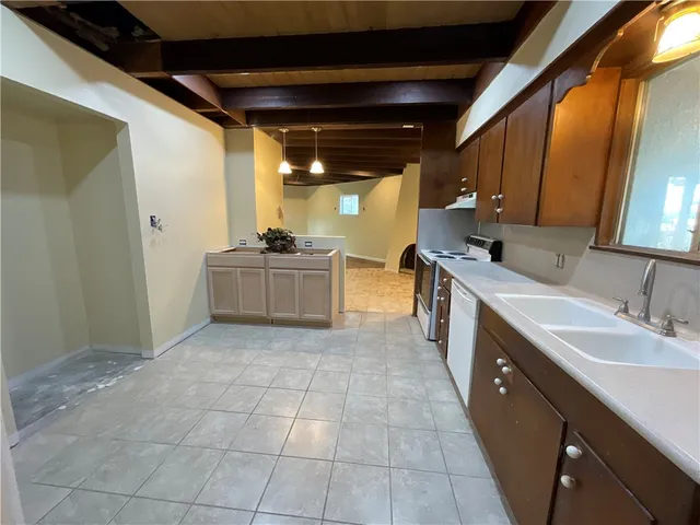 a large kitchen with a stove and cabinets