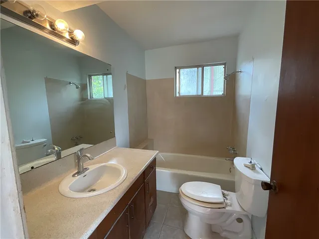 a bathroom with a sink toilet and a mirror