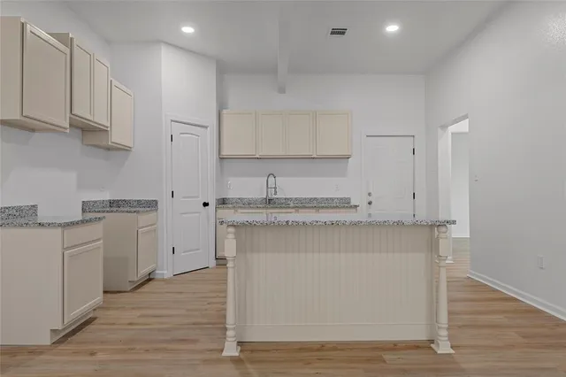 a kitchen with white cabinets and appliances