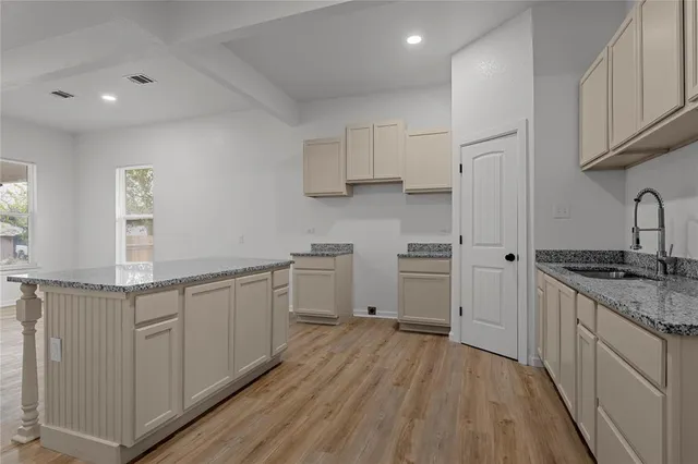 a kitchen with granite countertop white cabinets and white appliances