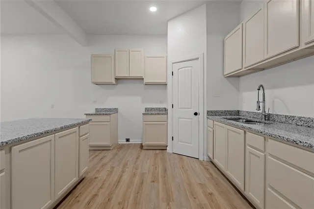 a kitchen with granite countertop cabinets and white appliances