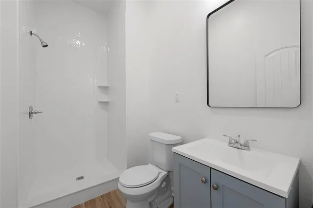 a view of empty room with wooden floor