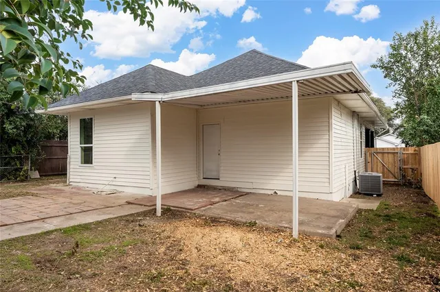 a backyard of a house with a tree
