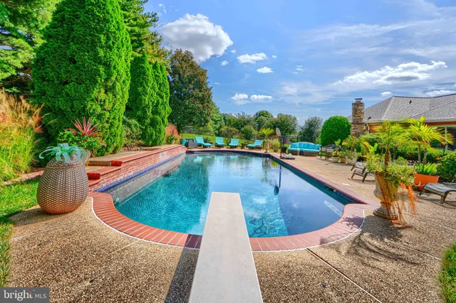 an aerial view of a house with swimming pool patio and outdoor seating