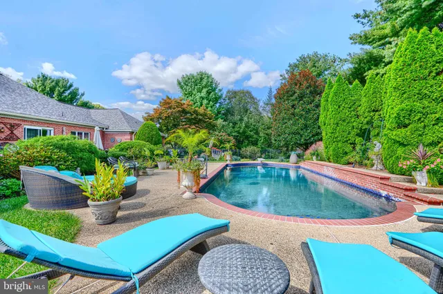 a view of a backyard with swimming pool