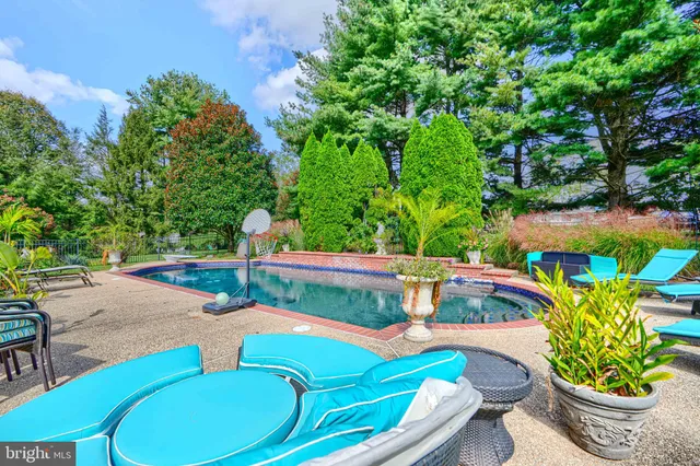a backyard of a house with yard table and chairs