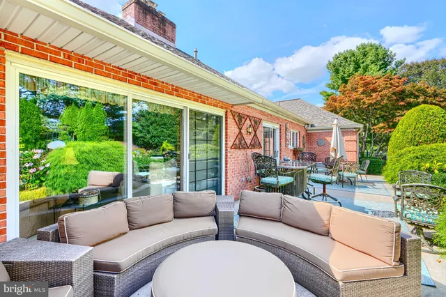 a living room with stainless steel appliances kitchen island granite countertop a stove and a sink