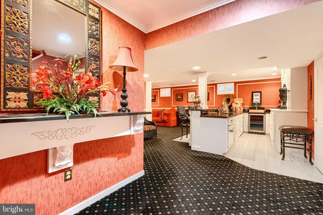 a living room with stainless steel appliances kitchen island granite countertop a refrigerator and cabinets