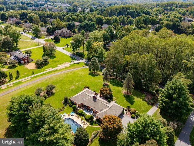 an aerial view of residential house with swimming pool and outdoor space