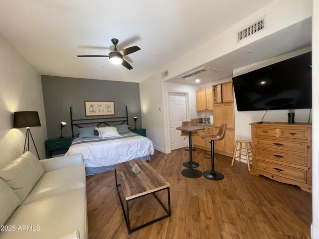 a bedroom with furniture and a flat screen tv
