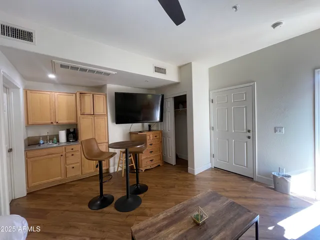 a living room with furniture wooden floor and a flat screen tv