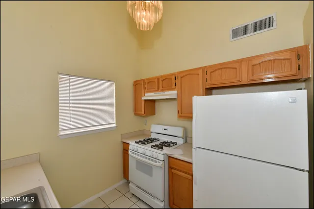 a kitchen with a stove and a refrigerator