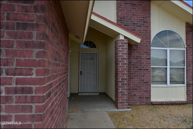 a brick building with a black door