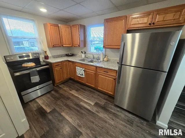 a kitchen with a sink stove and cabinets