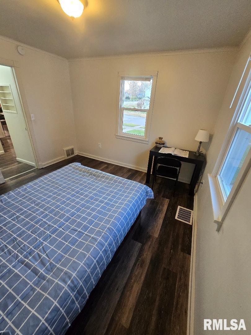 418 19th Avenue North Clinton, IA 52732 - Photo 23 of 28 a bed sitting in a bedroom next to a window